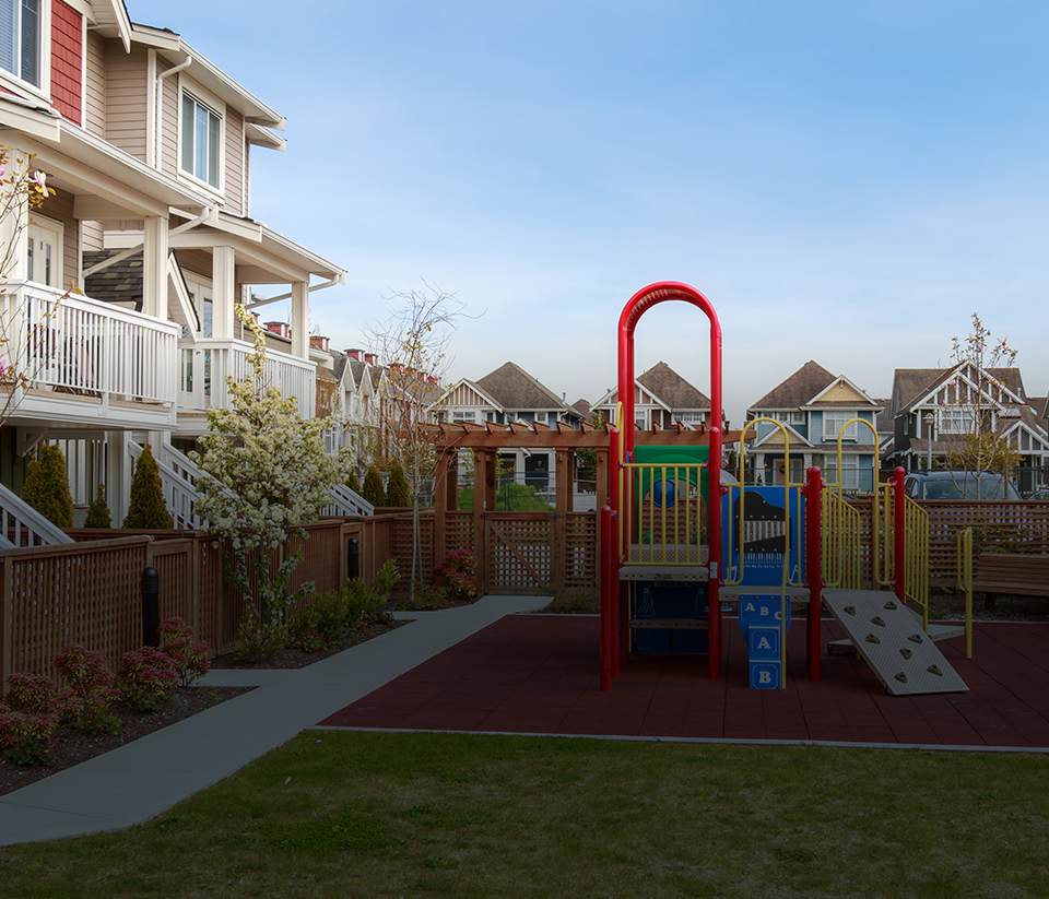 a playground behind a condo building